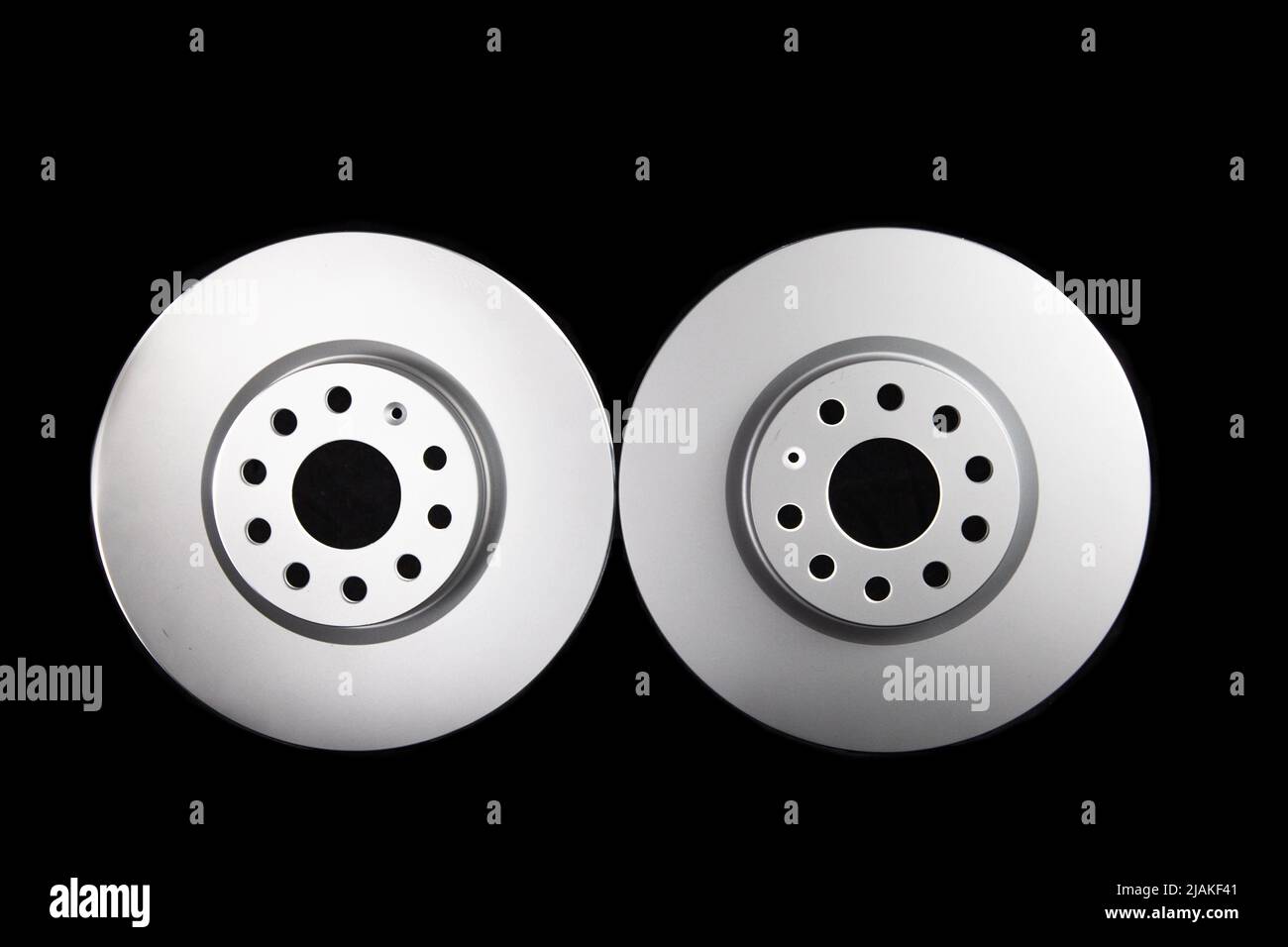 White brake discs on a black background. Efficient braking, safety. Stock Photo