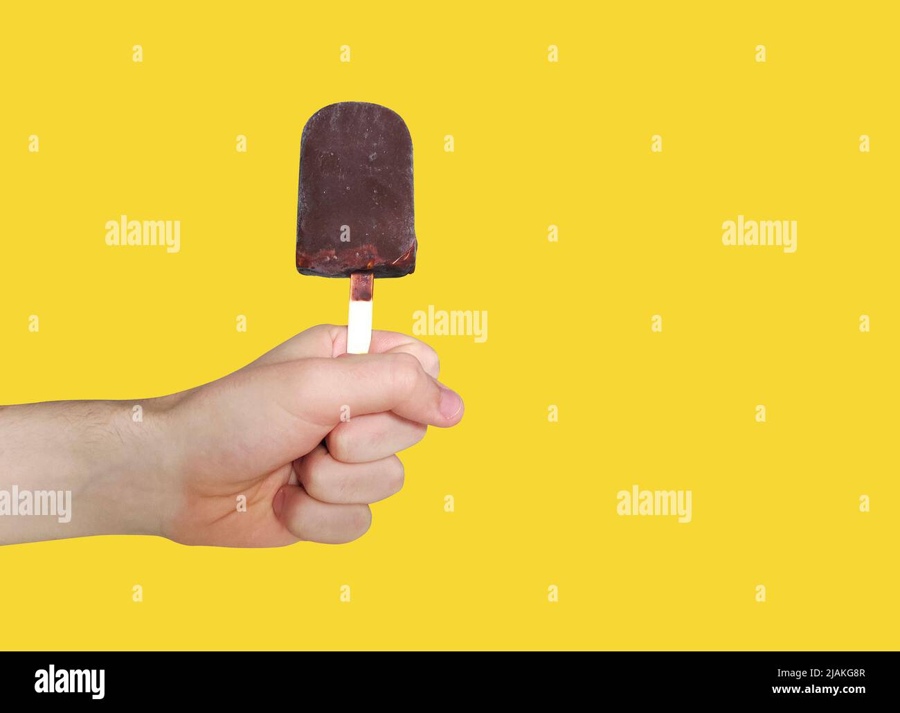 Chocolate ice-cream on yellow background. Popsicle. Eskimo Stock Photo