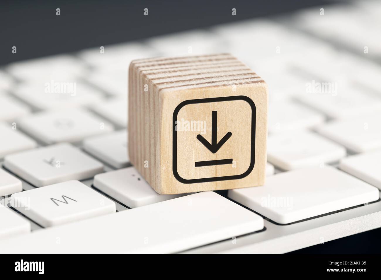 Download icon on wooden block on computer keyboard. Downloading data storage Stock Photo