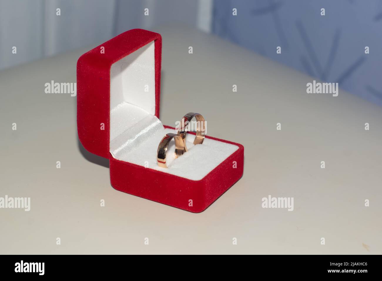 Two wedding rings in a red box for wedding rings. Stock Photo