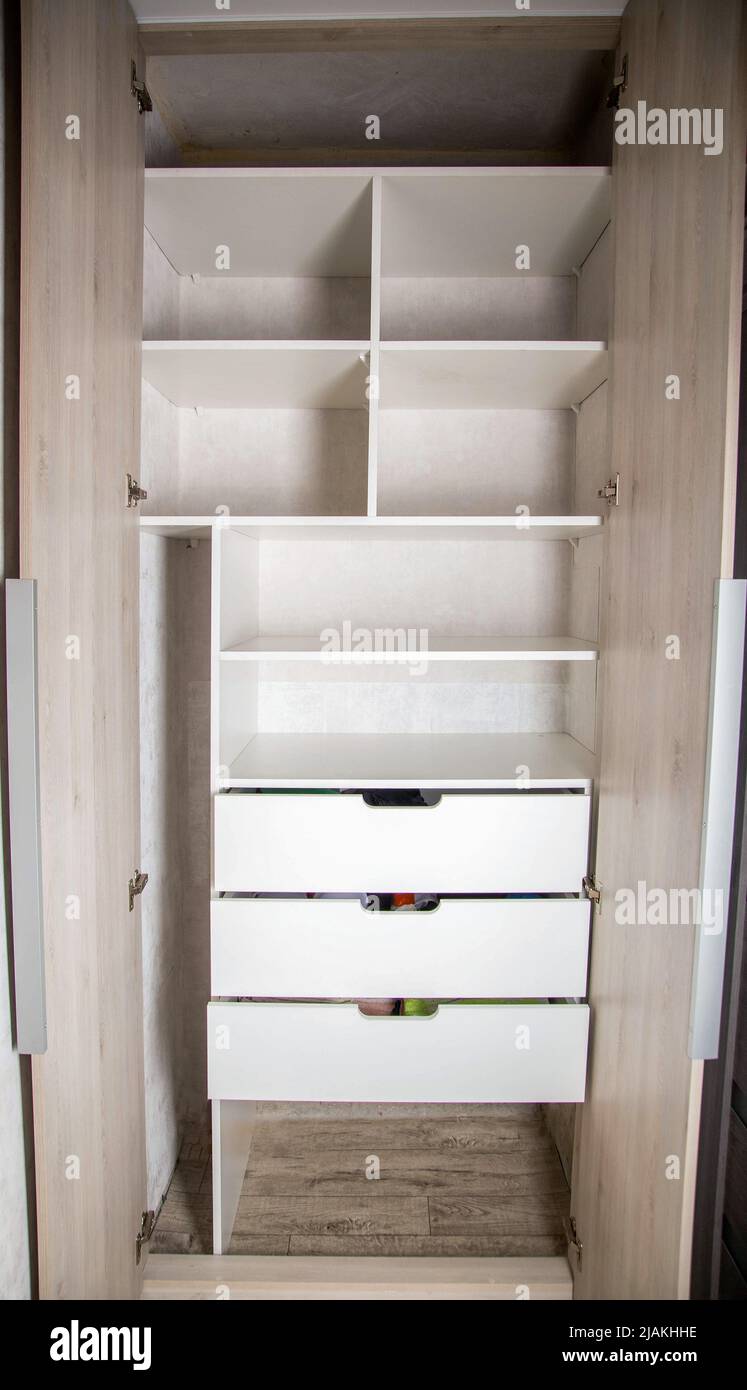 Modern closet in the hallway with hinged doors and pull-out shelves. Production of furniture under the order, organizer Stock Photo