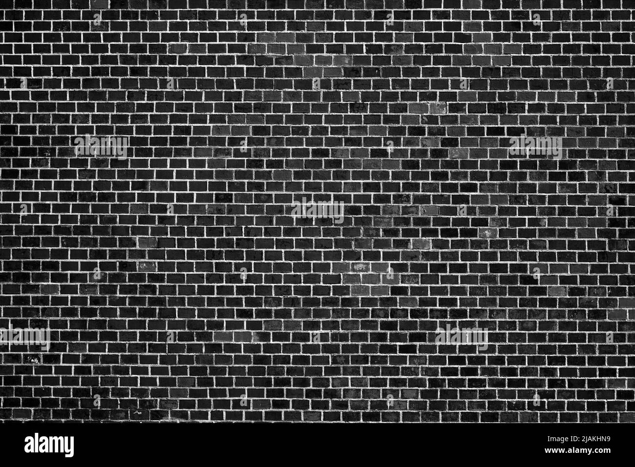 Old Black Brick Wall. An ancient fortress. Medieval brick building. Big Brick wall background texture. Stock Photo