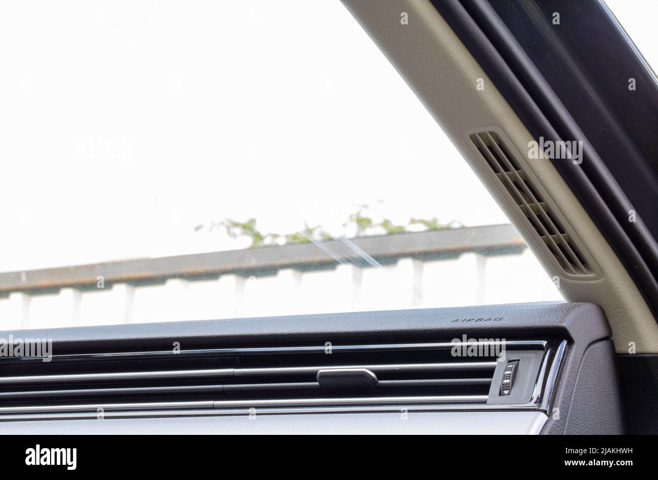 Air ducts on the car panel for blowing the windshield with warm air