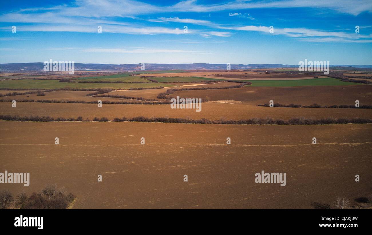 Drone photo of industrial buildings grain silos to plowed unsown fields ...