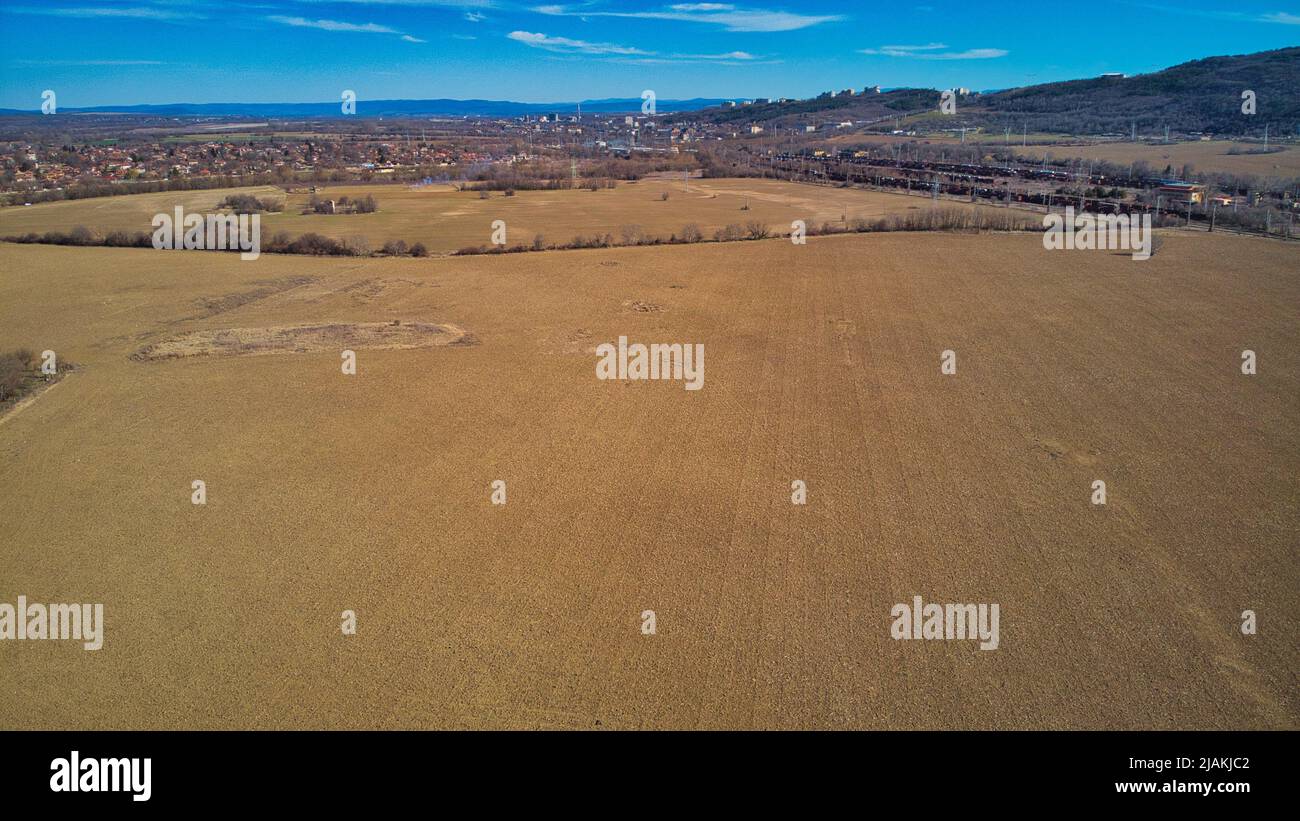 Drone photo of industrial buildings grain silos to plowed unsown fields ...