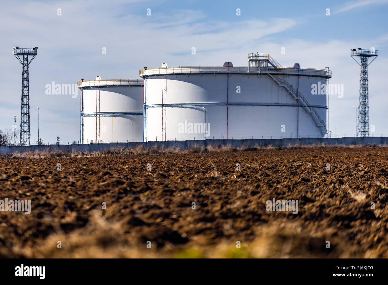 White grain silos to plowed unsown fields Stock Photo - Alamy