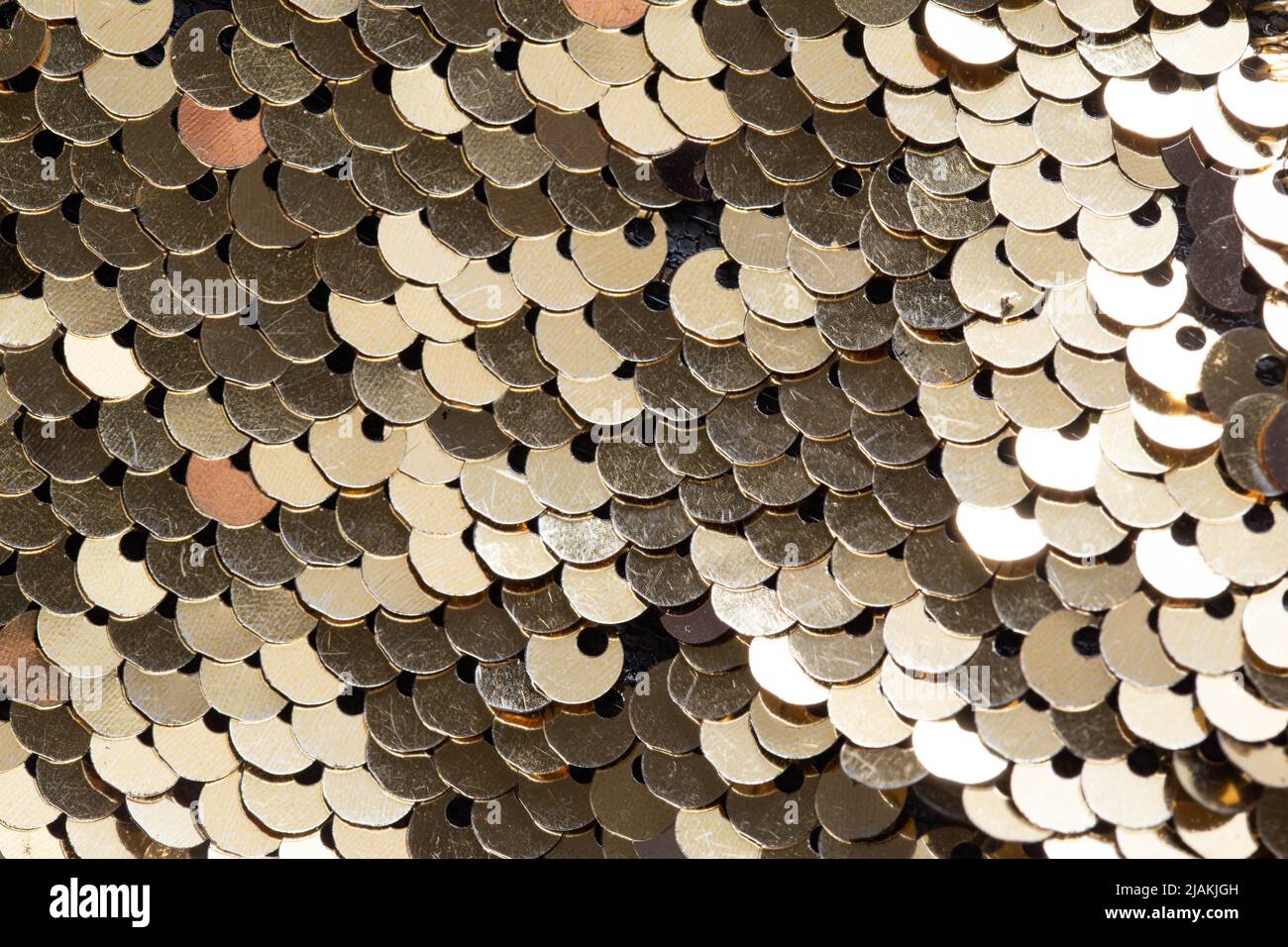 golden sequins on clothes background, macro Stock Photo