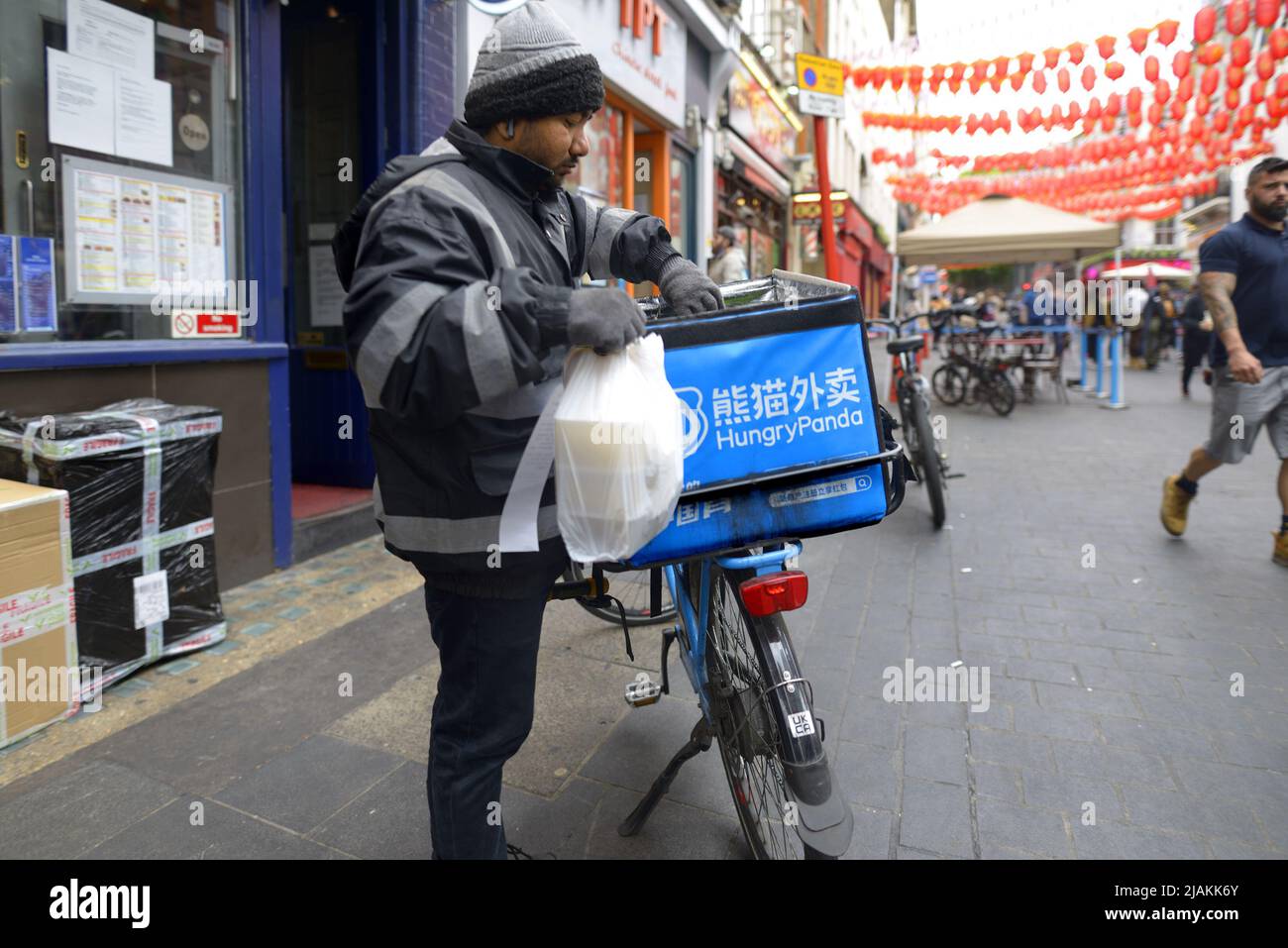 London, England, UK. Hungry Panda food delivery rider in Chinatown Stock Photo