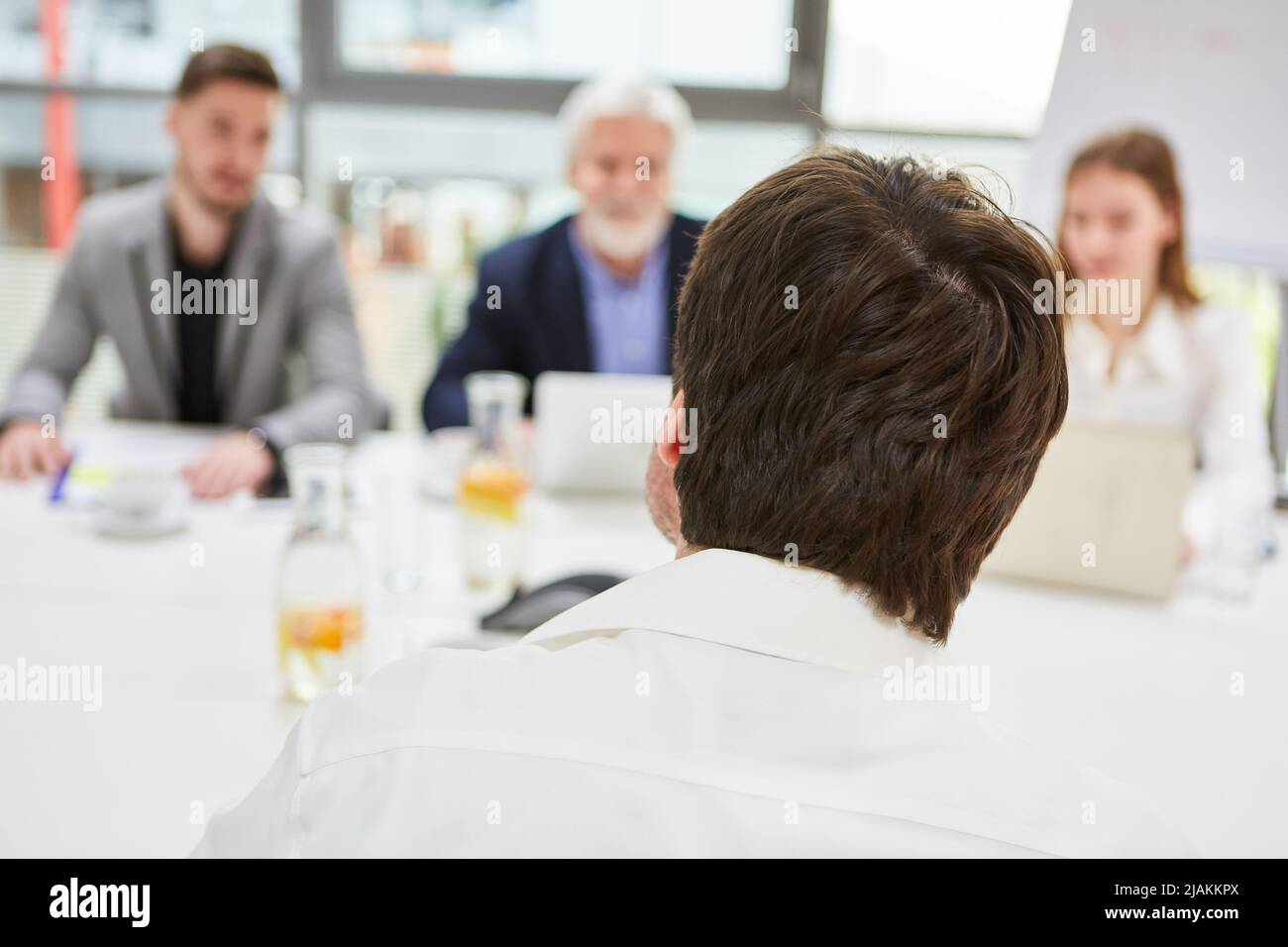 Man as applicant in job interview or job interview with employer Stock Photo