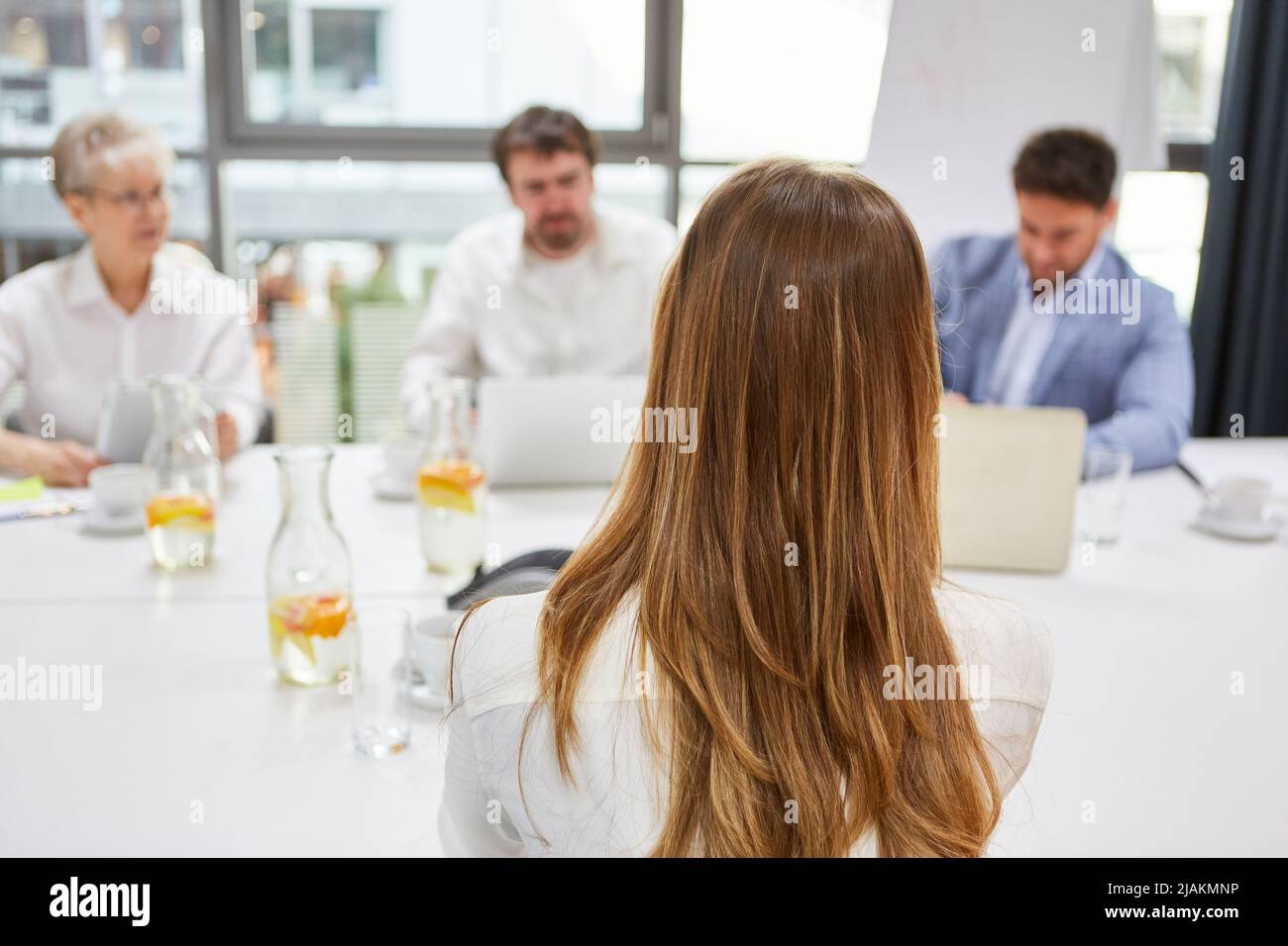 Young woman as an applicant at the interview with HR and manager Stock Photo