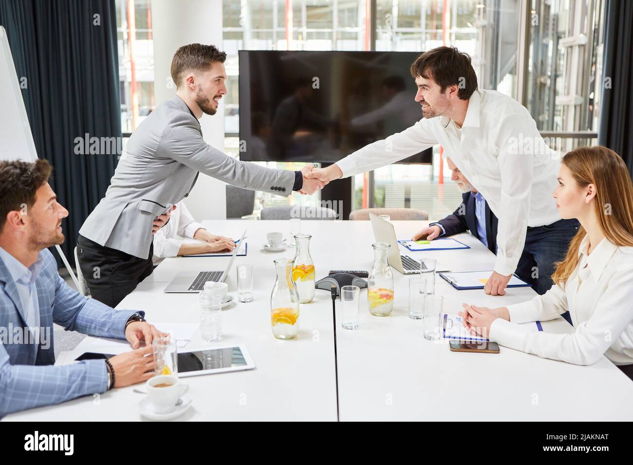 Business partners shaking hands in meeting as concept for cooperation and deal Stock Photo