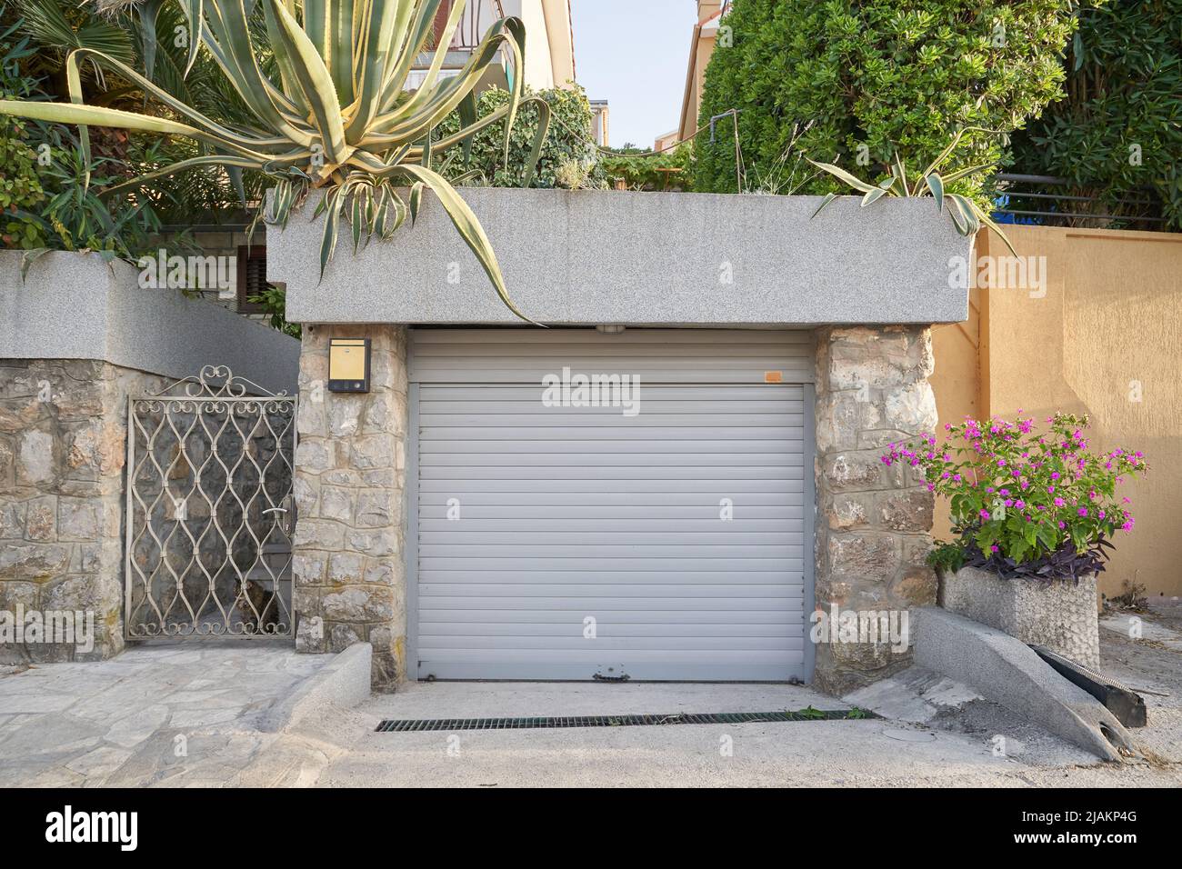 Garage with gray door and greenery on the roof Stock Photo