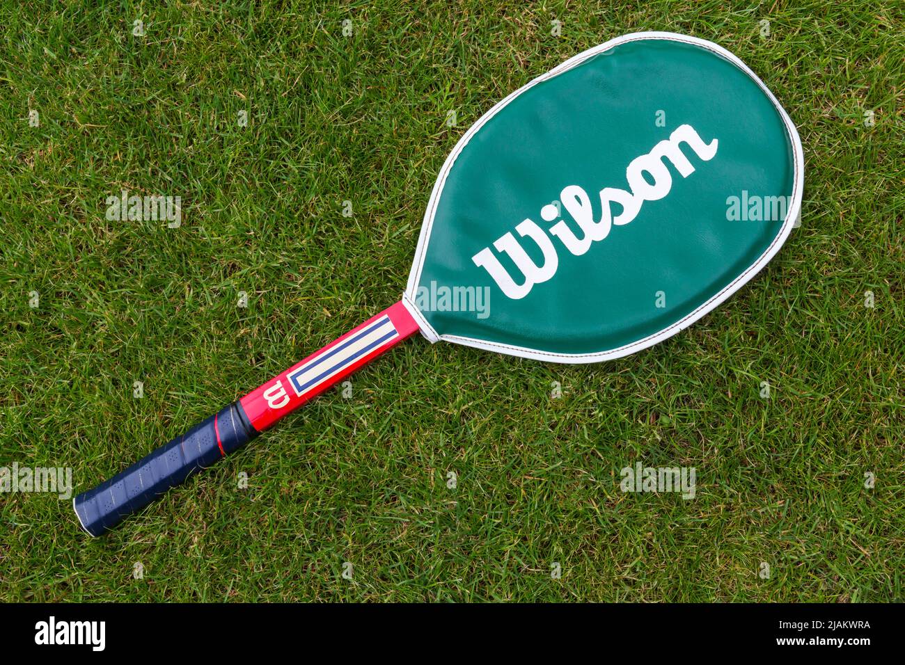 Wilson tennis racket, Wilson tennis racquet, on grass lawn Stock Photo