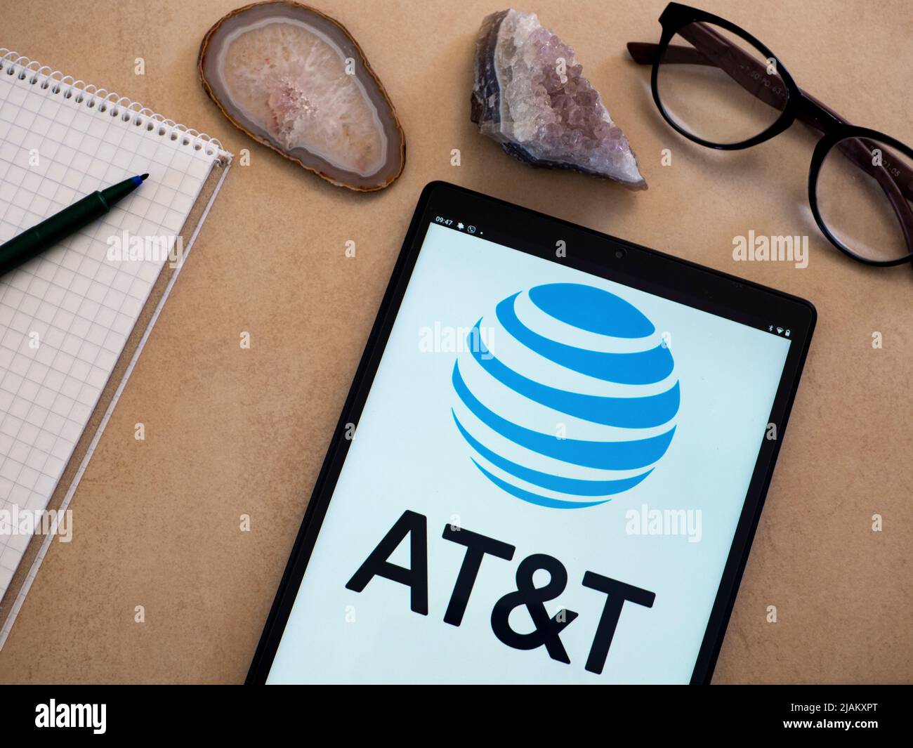 In this photo illustration AT&T Inc. logo seen displayed on a tablet ...