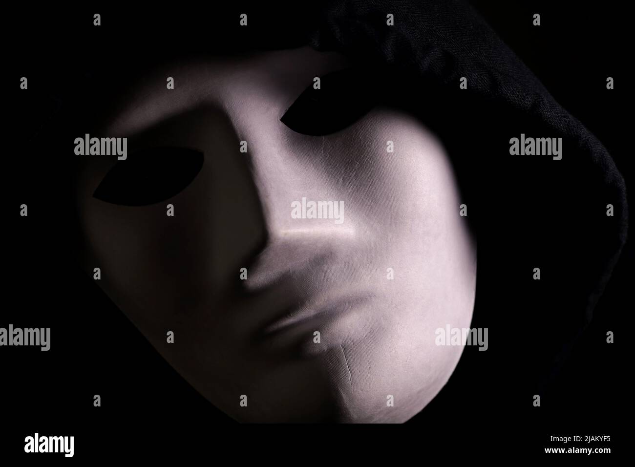 portrait of a person with a mask on a dark background Stock Photo - Alamy
