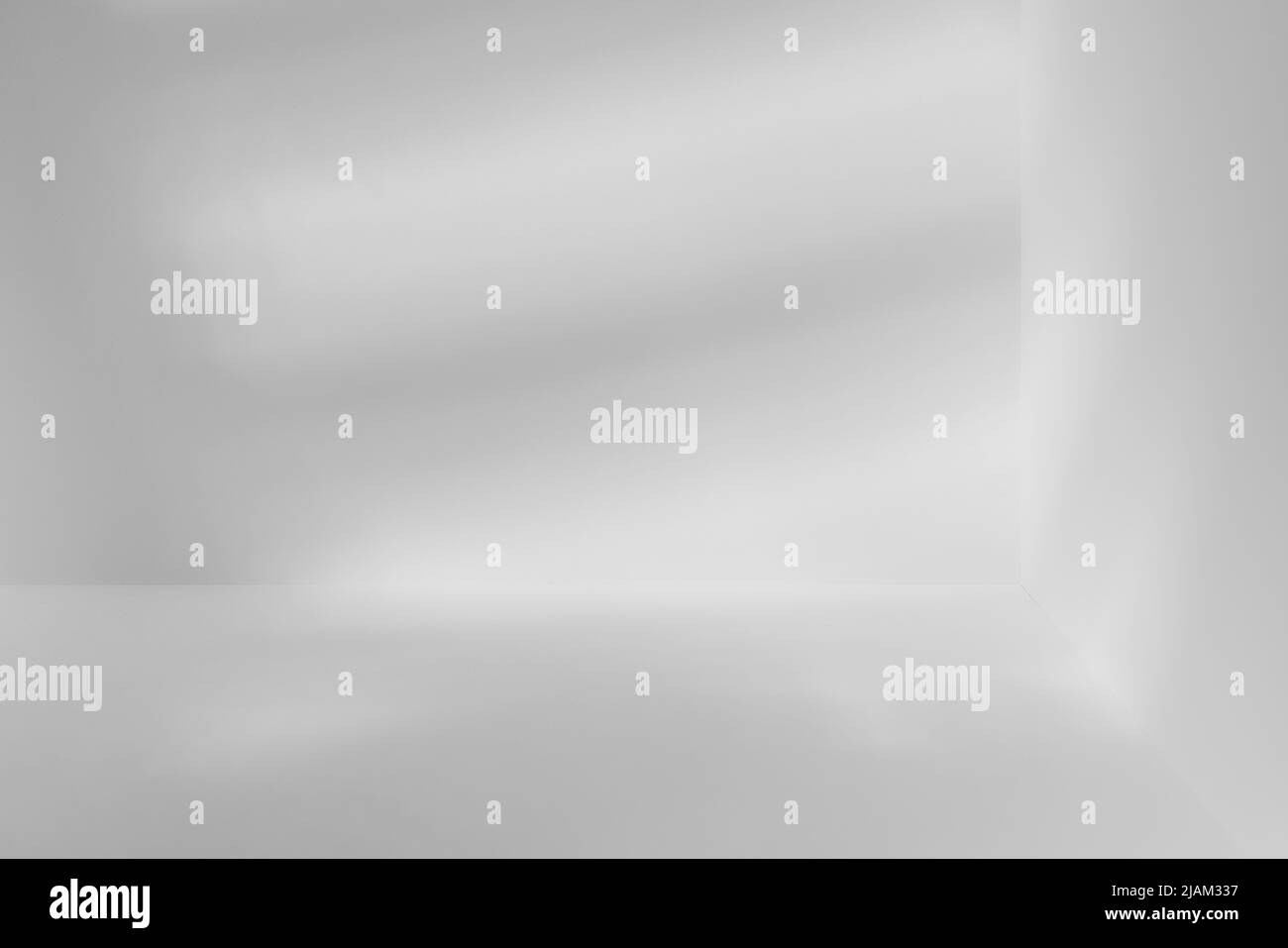 Empty light studio corner with light striped shadow. Sparse template and background Stock Photo