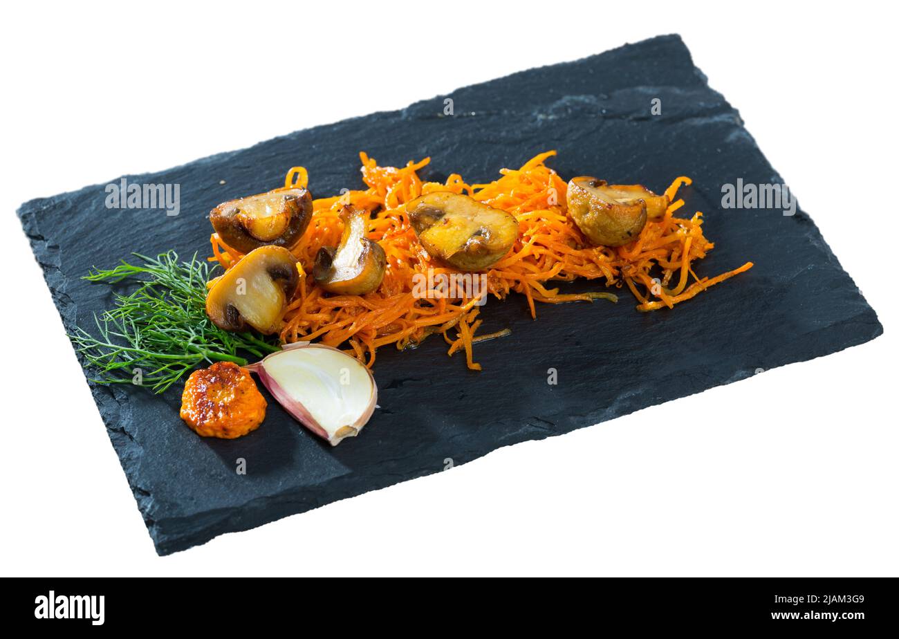 Roasted champignons with julienne carrots Stock Photo