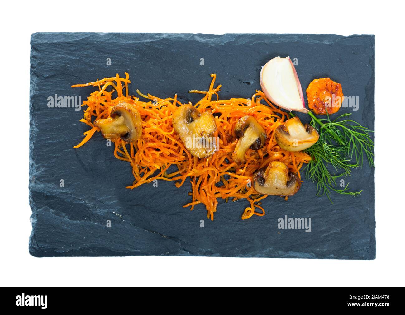 Roasted champignons with julienne carrots Stock Photo
