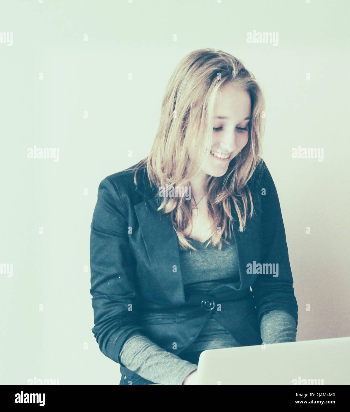 Pretty young woman working on her laptop Stock Photo - Alamy