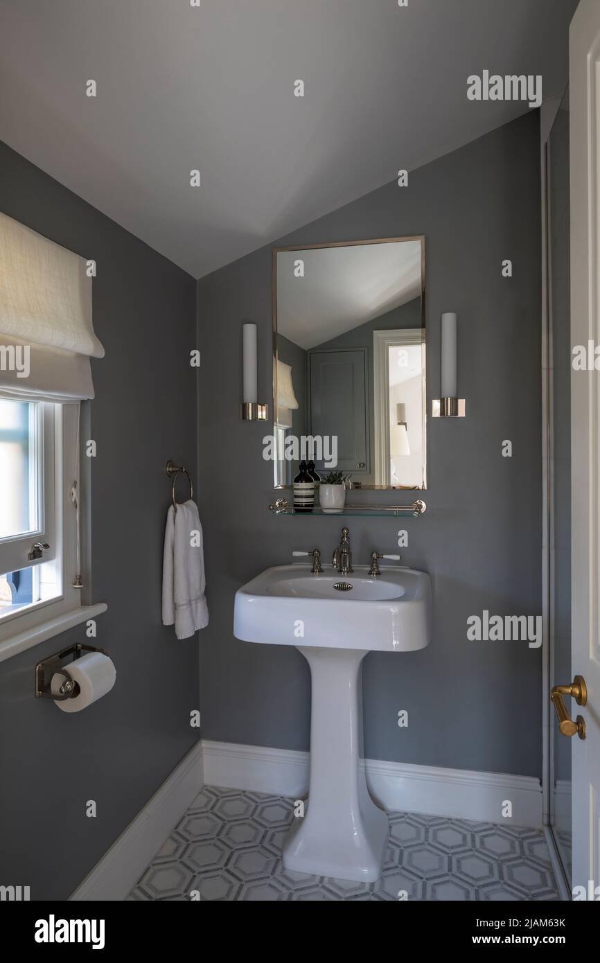 Small grey themed shower room in Victorian house Stock Photo