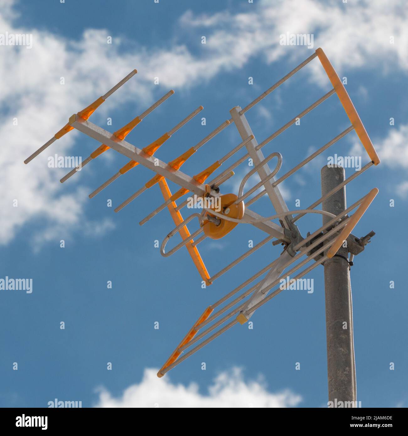 television antenna on a rooftop in front of a blue sky Stock Photo Alamy