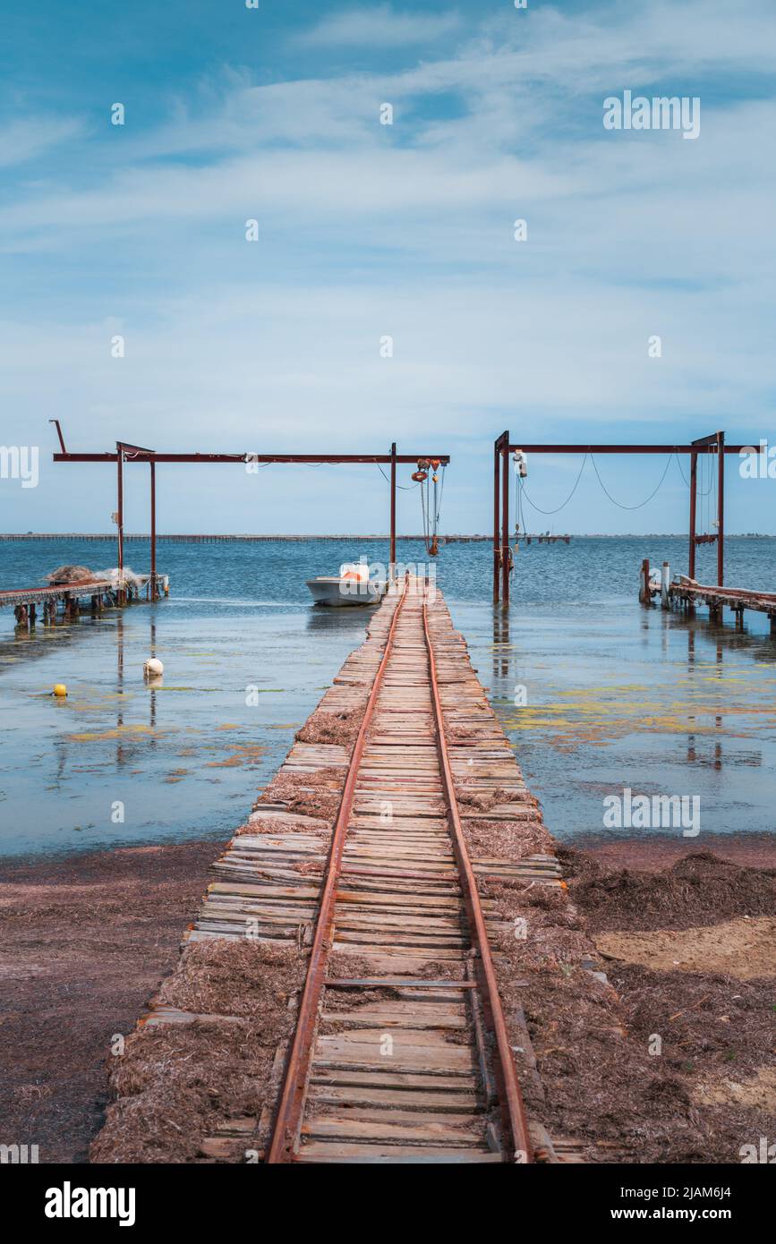 Wooden piers and boats for the oyster farm in Etang de Thau in South France Stock Photo