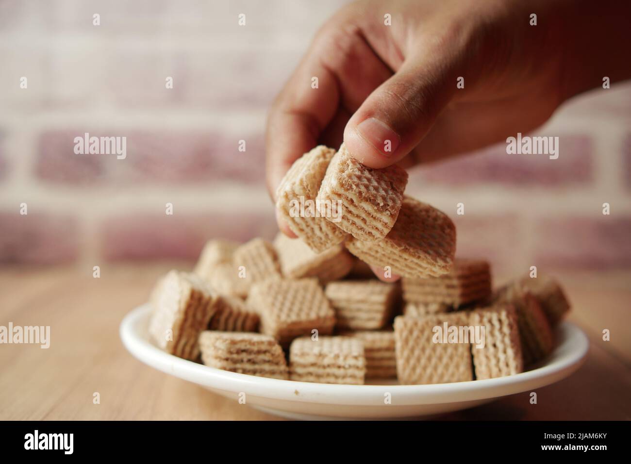 hand pick a small cube shape wafer roll chocolate Stock Photo