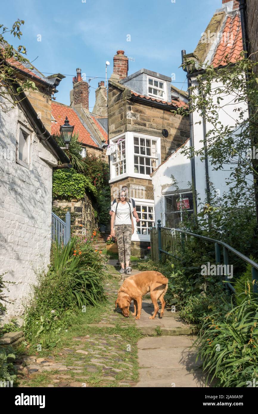 Visitors walking through tiny streets in Robin Hood's Bay, North
