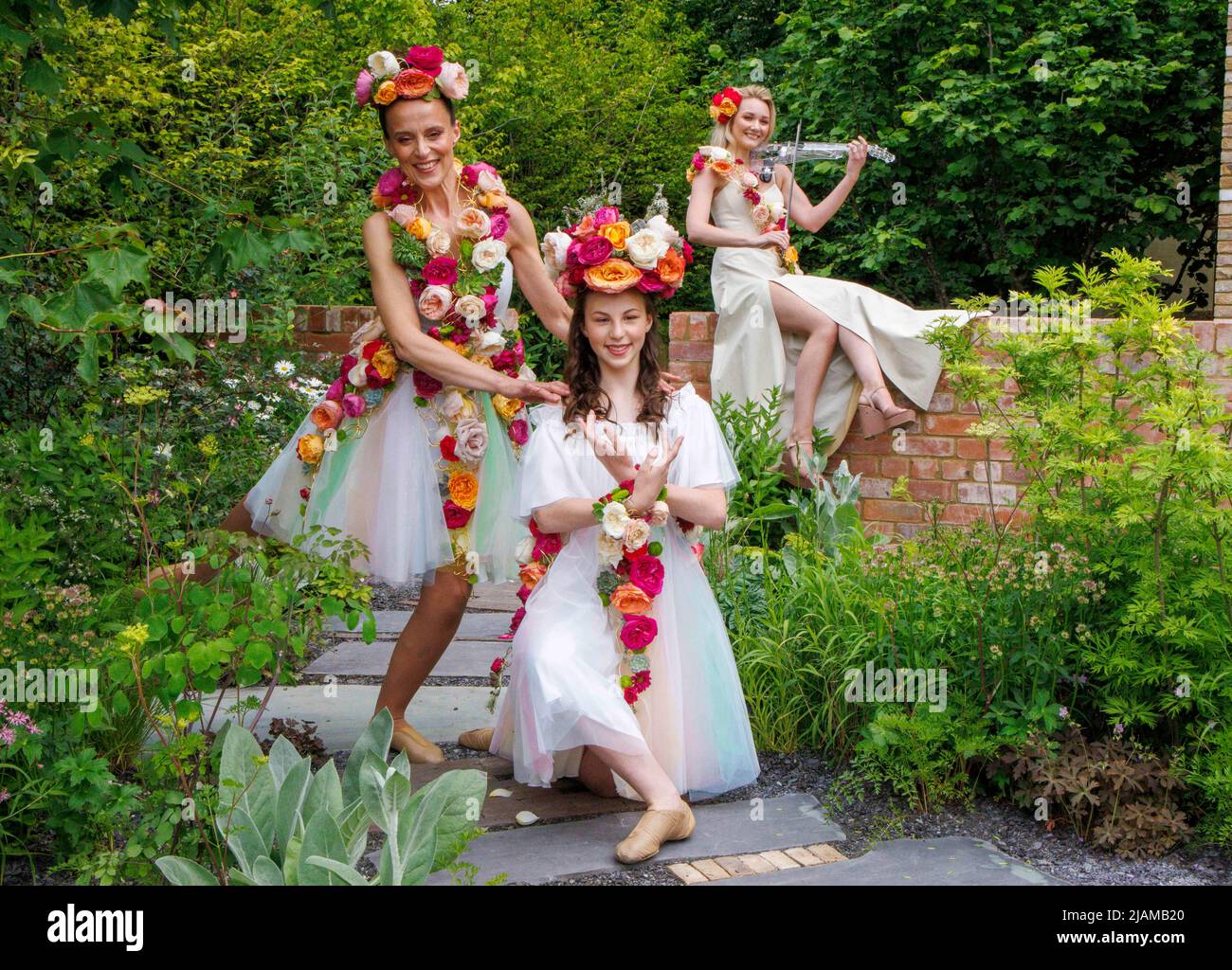 Women with floral displays at the RHS Chelsea Flower Show in the grounds of the Royal Hospital. Stock Photo