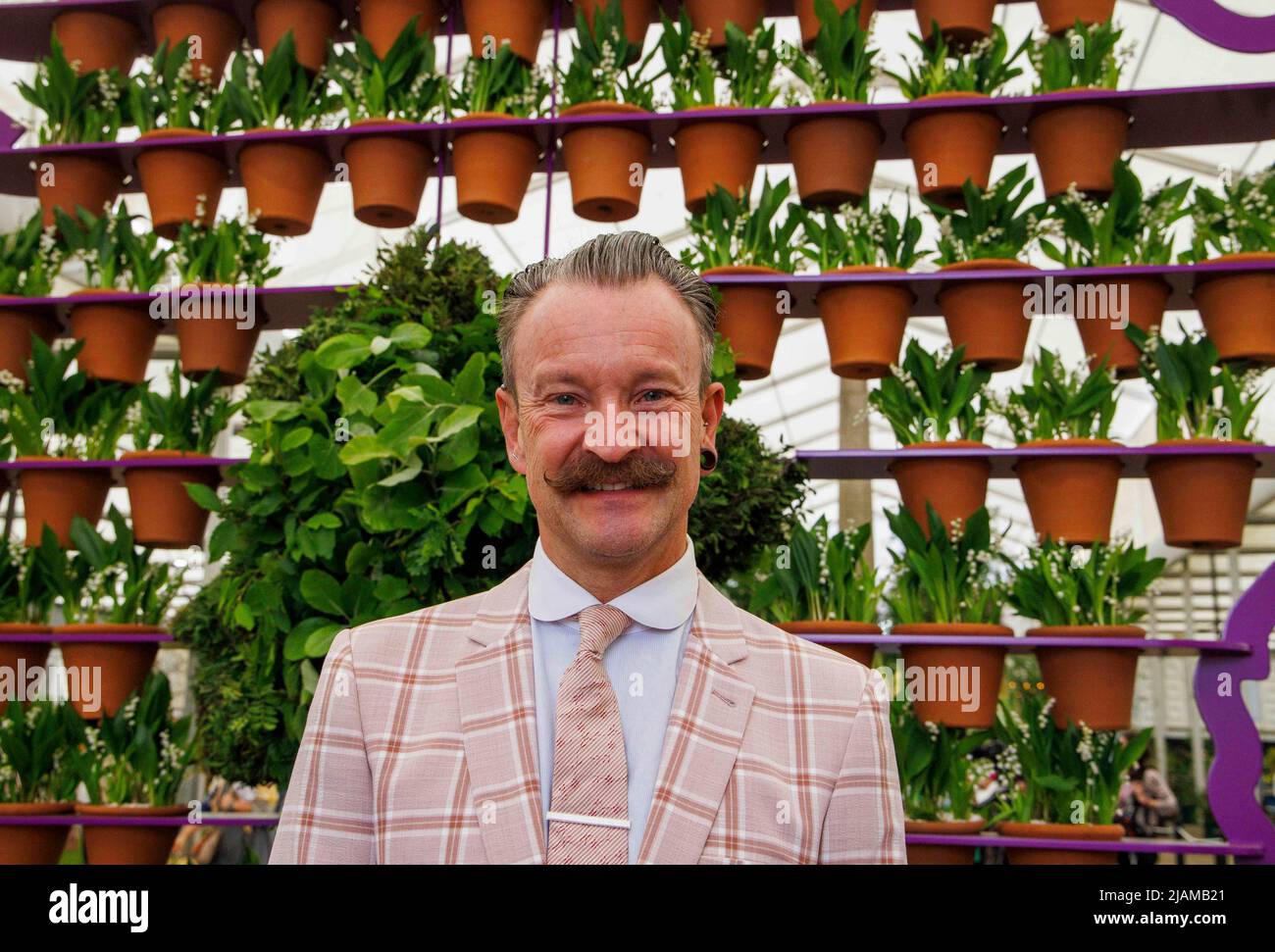 Renowned florist, author and presenter, Simon Lycett, with his display of 70 pots, one for every year of Queen Elizabeth the Second's reign. Stock Photo