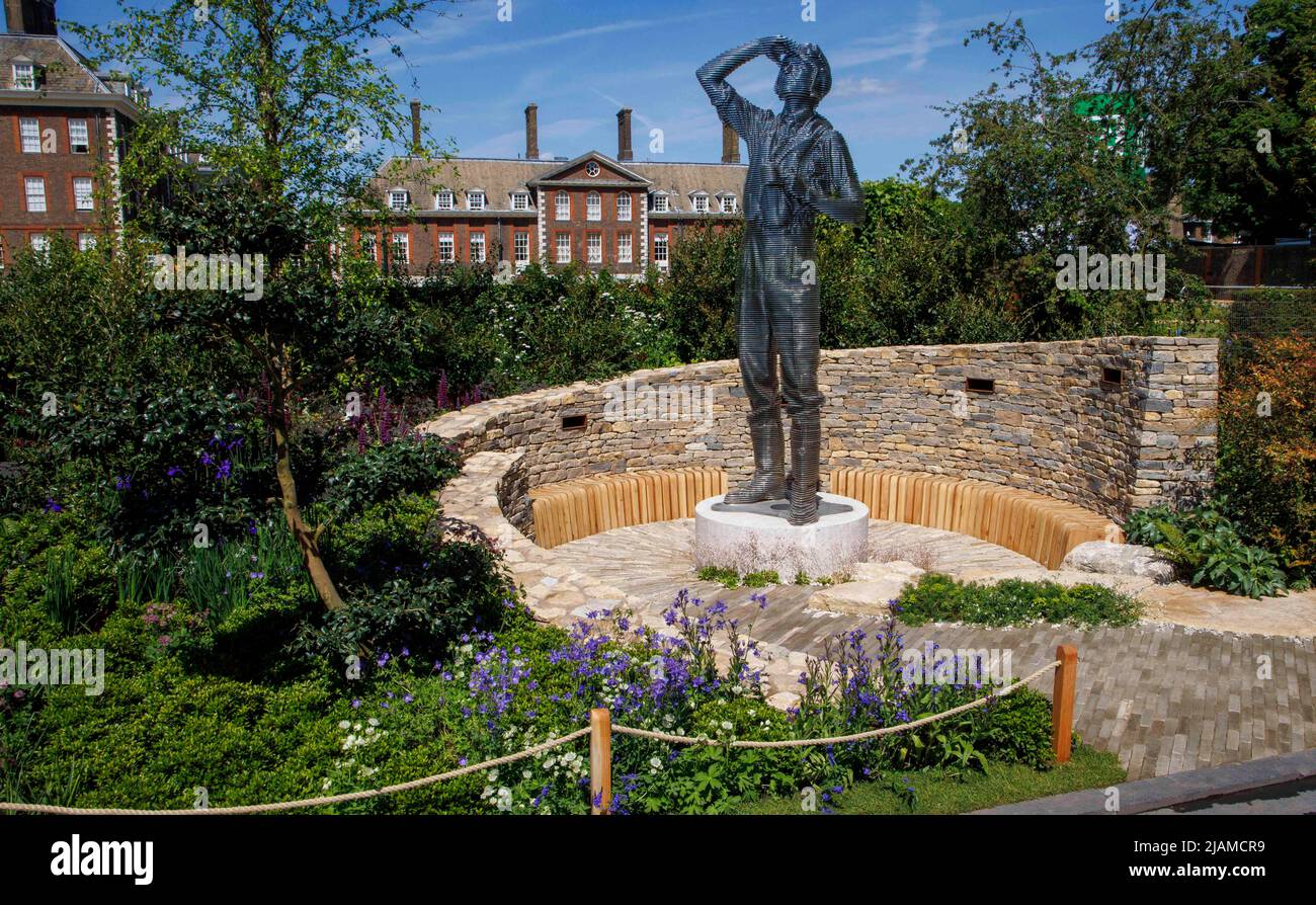 The RAF Benevolent Fund Garden. A young pilot looks up at the sky, walting to return to his Spitfire during the Battle of Britain, a designer garden. Stock Photo