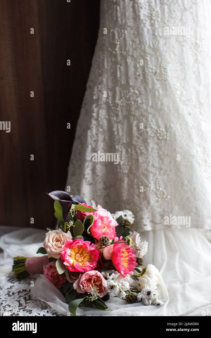 Elegant wedding bouquet on a wedding dress. Stock Photo
