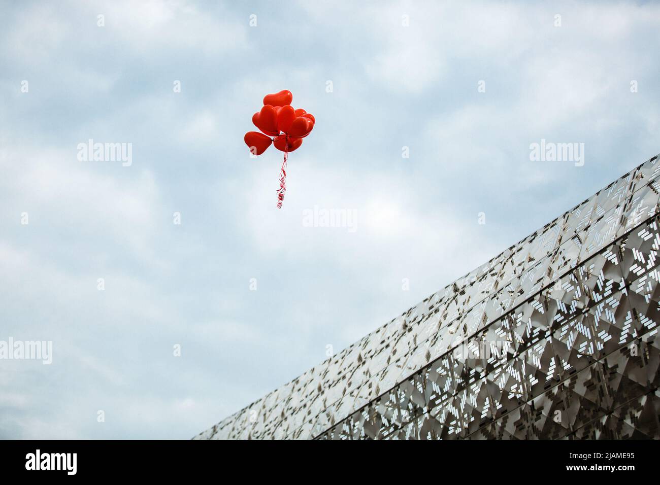 Bunch of red balloons in the sky. Stock Photo