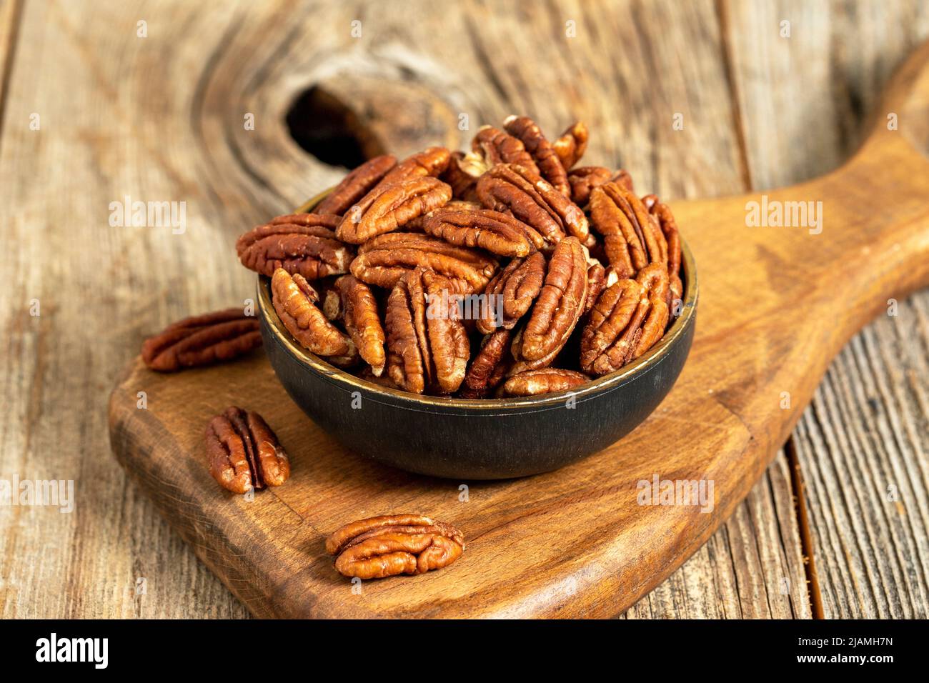 Pecan walnuts on wooden background. close up Stock Photo