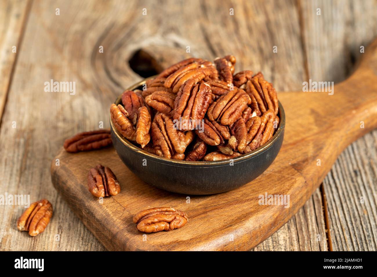 Pecan walnuts on wooden background. close up Stock Photo