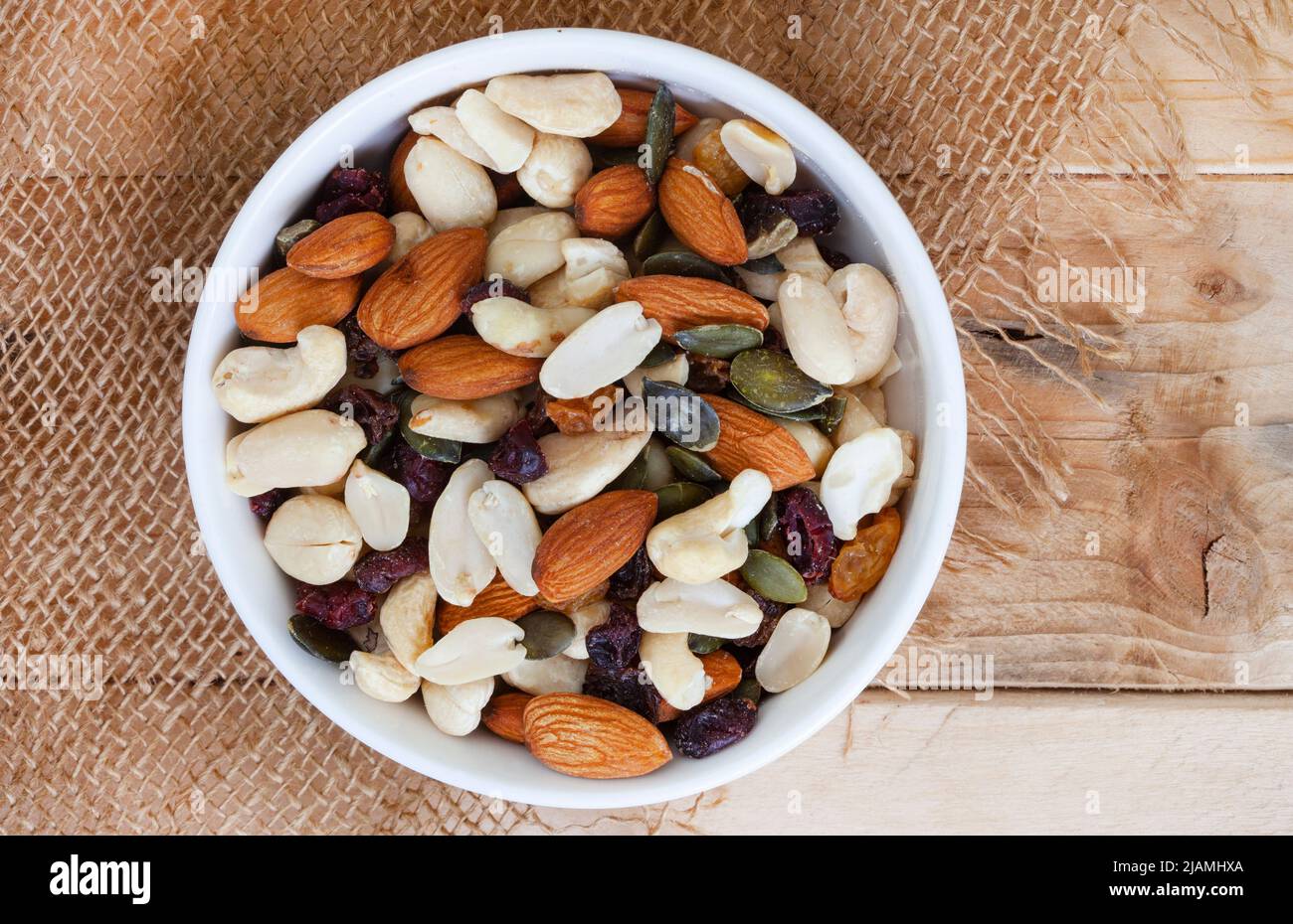 trail mix with nuts and cranberries on rustic grunge background with ...