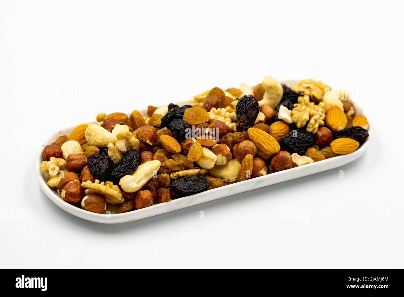 Mixed nuts on white background. Nuts, walnuts, raisins and cashews. close up Stock Photo
