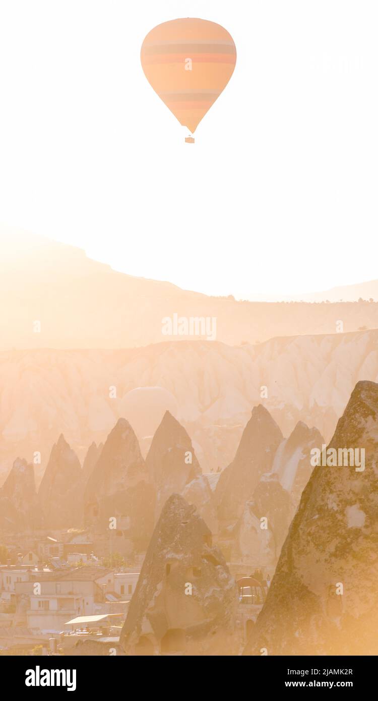 a balloon at fairy chimneys at sunrise in Göreme, Cappadocia Stock ...