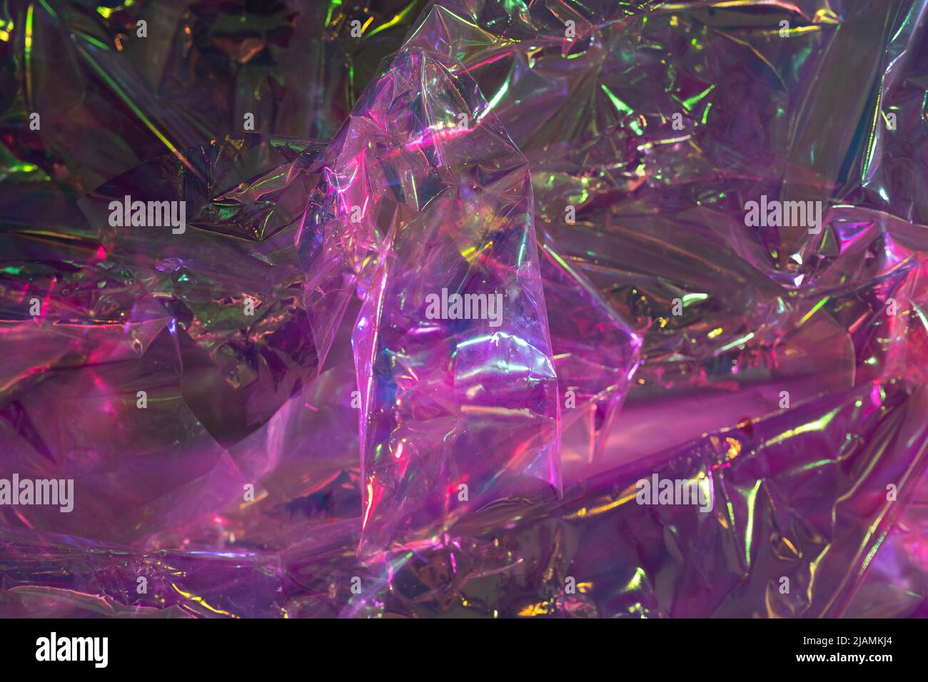 Crumpled cellophane. Purple polyethylene film background. Texture of violet pink plastic garbage bag Stock Photo