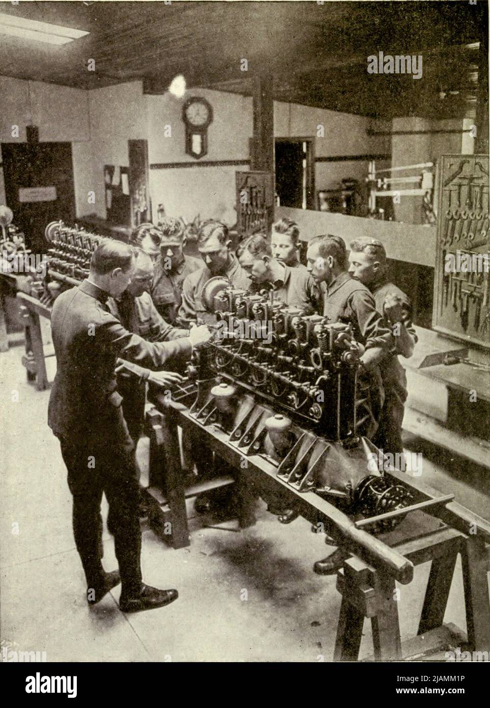 This picture, take- at one of the 'Ground Schools' of the Army Signal Corps, well illustrates the earnestness and concentration of the men. The instructor is obviously having no dif- ficulty in keeping his men at work, for these future American airmen know just as well as he how vital it is that they should understand every impulse of the engine which will soon mean so much to them in midair. A most thorough and fundamental course of training in engines is necessary for the men who carry the respon- sibility for America's warfare in the skies from the manual ' Practical aviation for military a Stock Photo