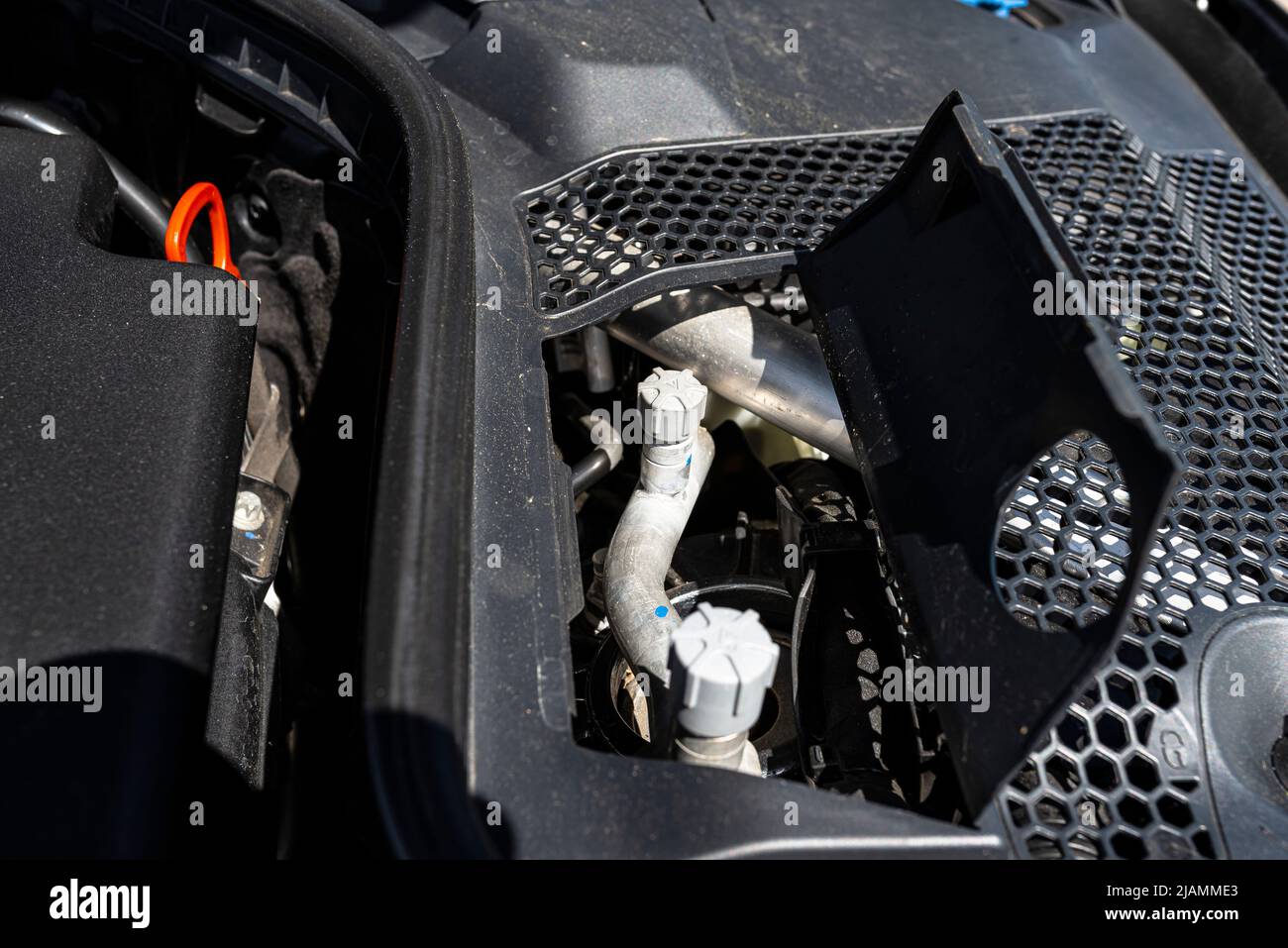 Aluminum air conditioning tubes with a cap, located in the diesel engine compartment. Stock Photo