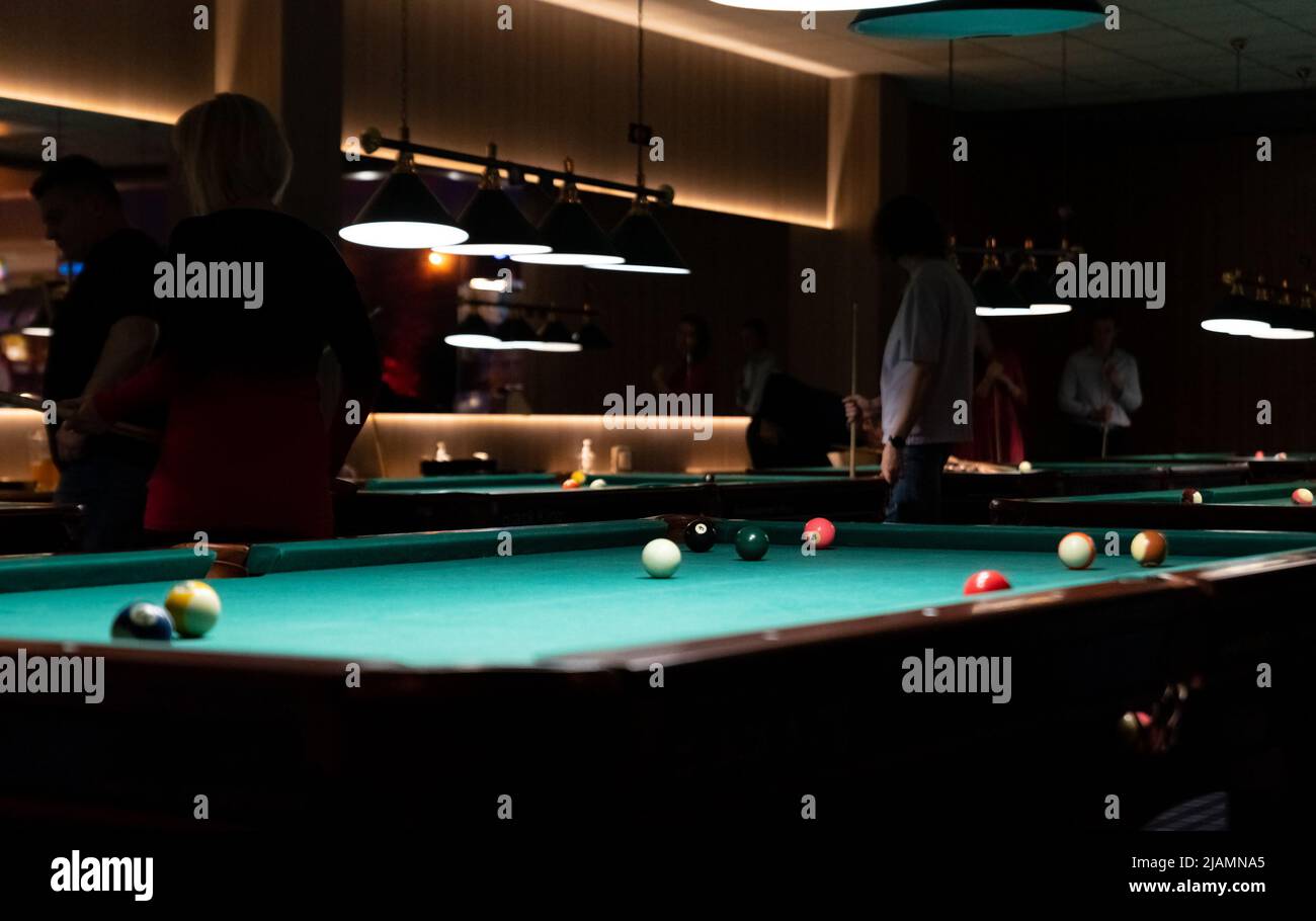 Pool tables for party games. Spending free time. A dark, atmospheric room  with pool tables and billiards Stock Photo - Alamy