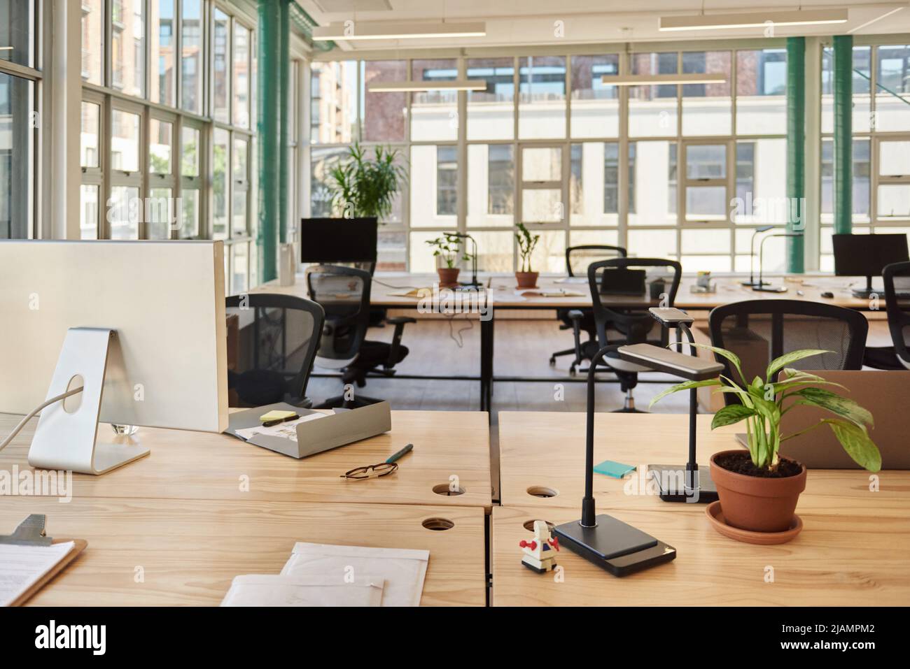 Desk in a modern office space after working hours Stock Photo