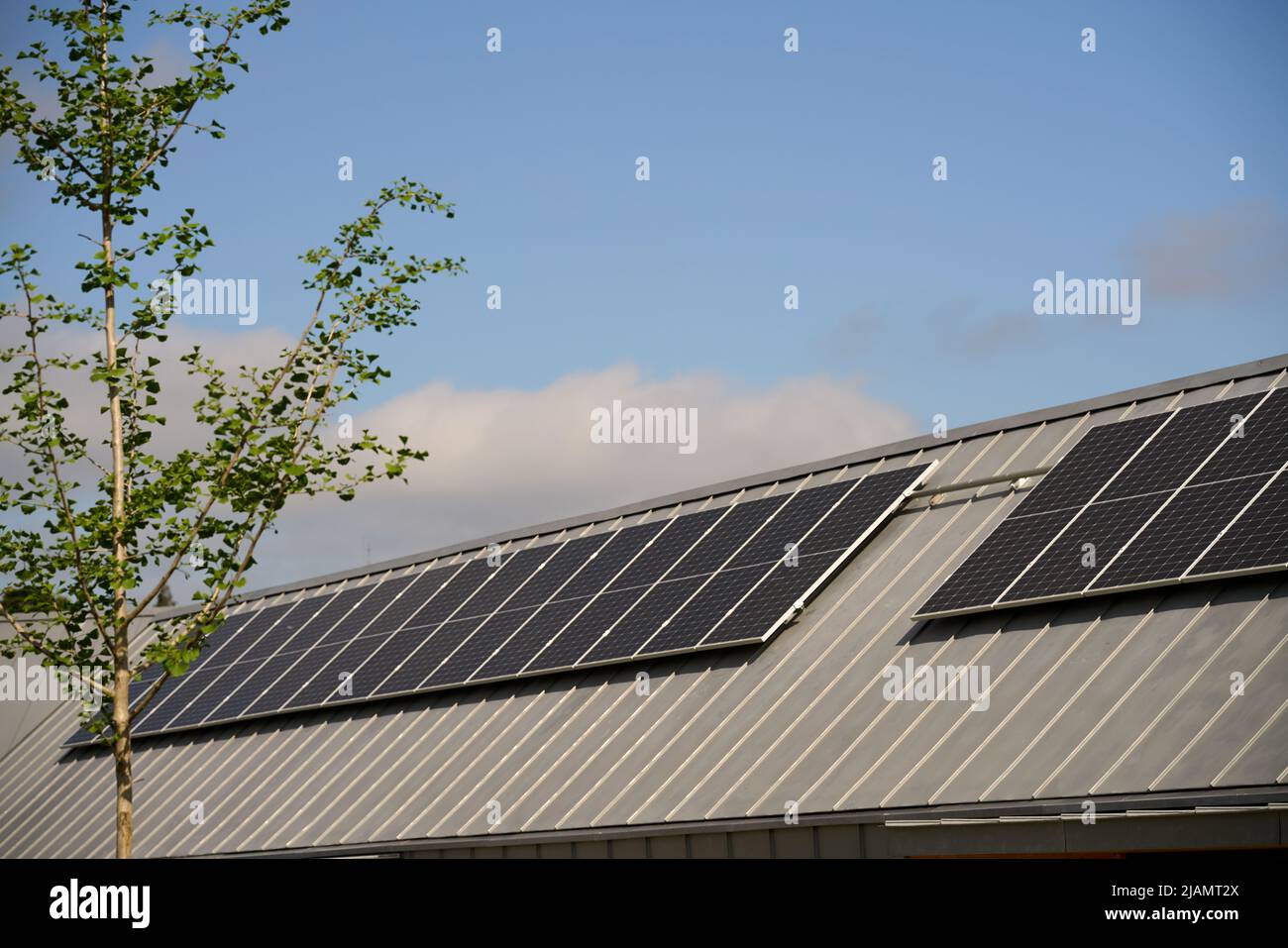 State-of-the-art solar panels placed on the roofs of houses of ecological construction Stock Photo