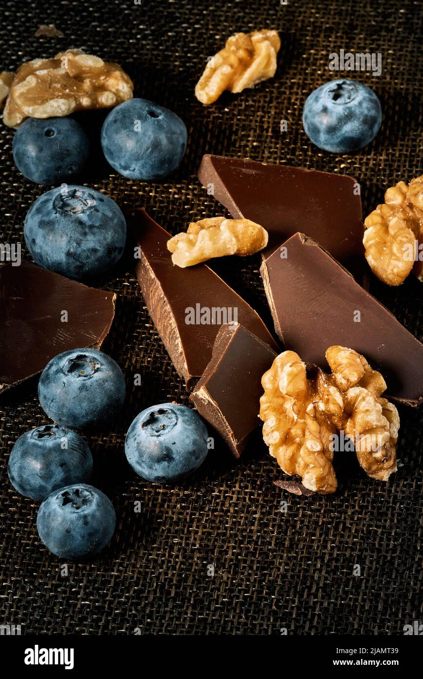 Chocolate, nuts and blueberries prepared for a healthy meal Stock Photo