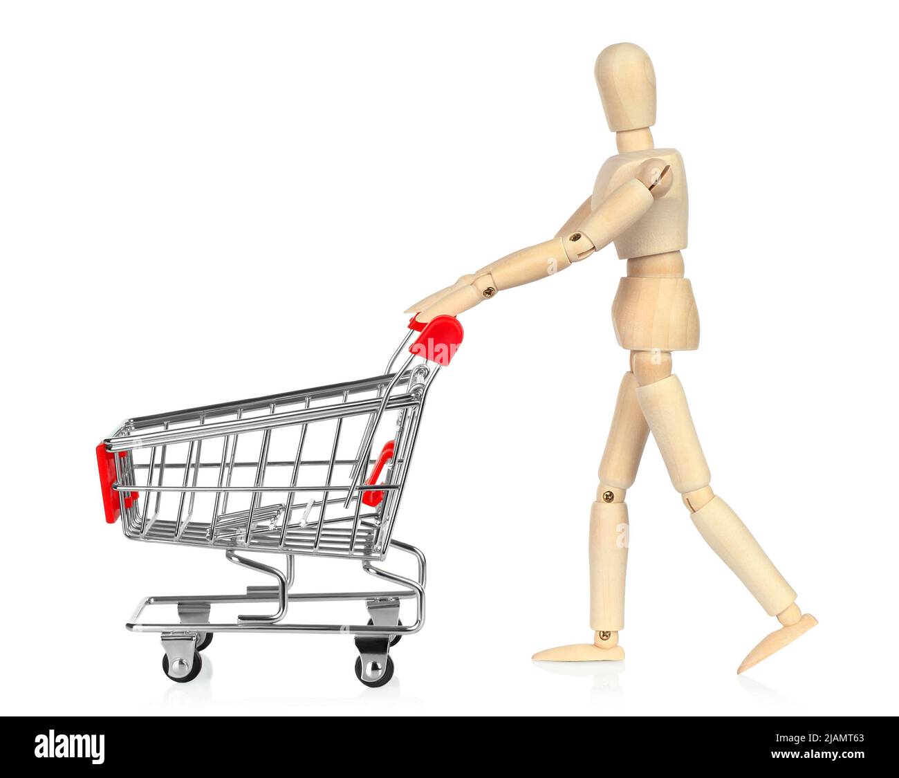 Wooden Manikin with shopping cart, shopping concept on white background close-up Stock Photo