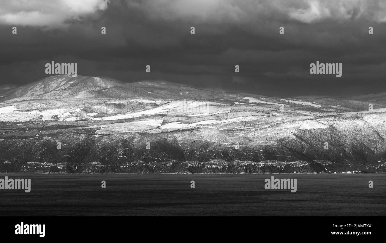 Snowy mountains and seascape. black and white nature landscape Stock Photo