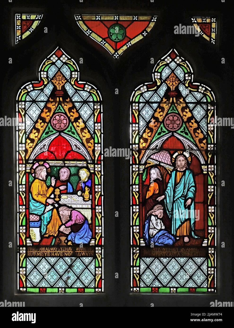 A stained glass window by Frederick Preedy depicting Mary Magdalene washing Jesus's feet and Jesus rebuking the accusers of the woman of adultery Stock Photo