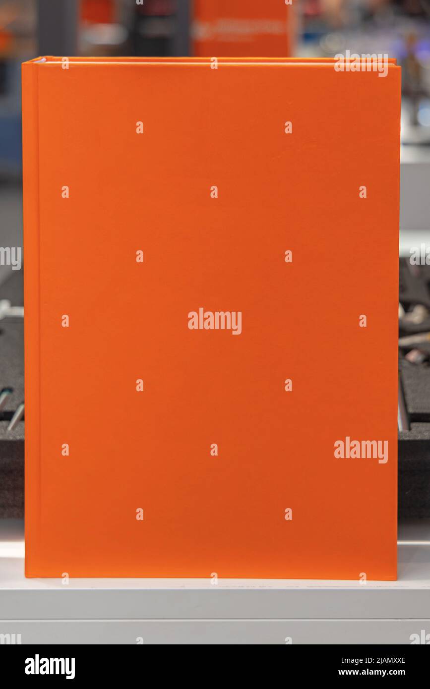 Big Orange Book Cover Catalog in Vertical Position Stock Photo