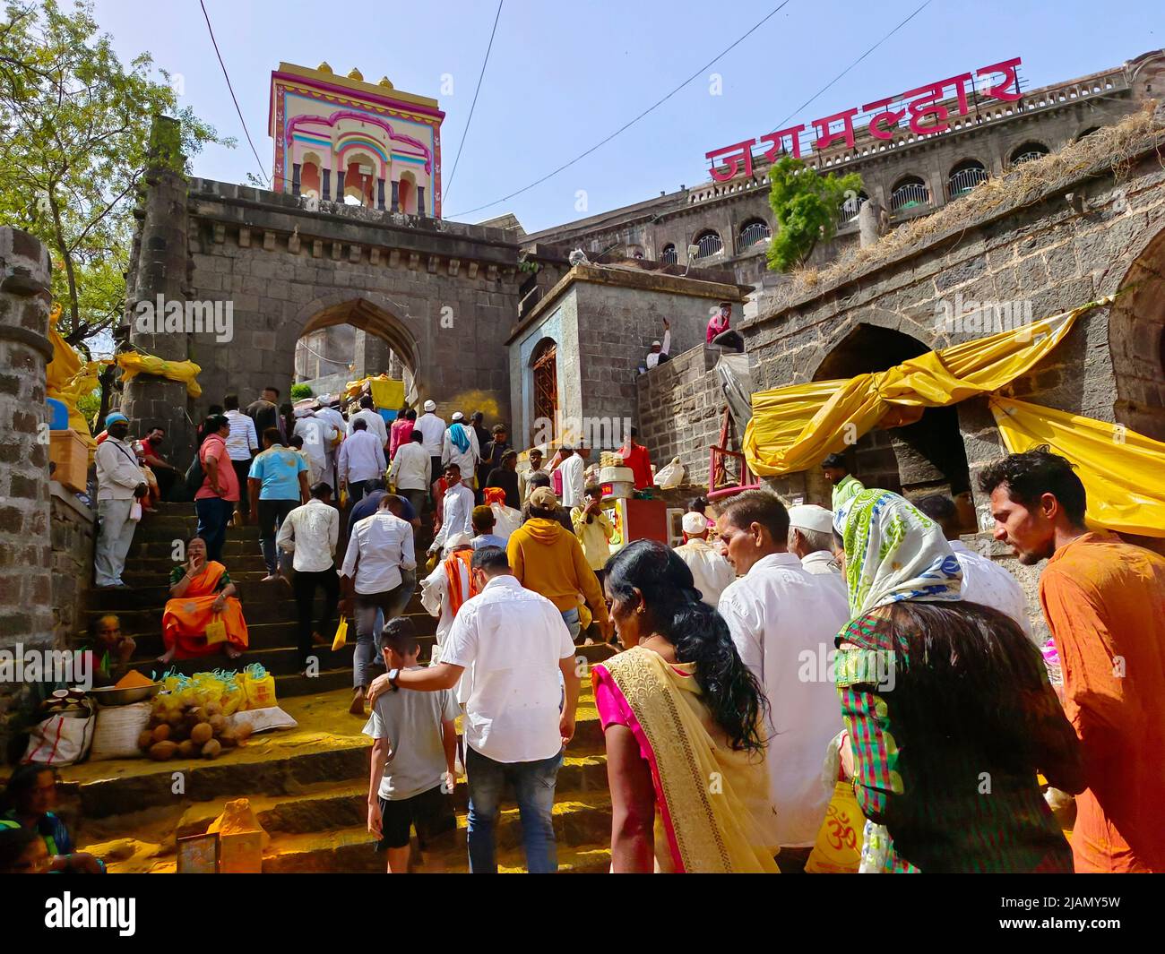 Jejuri, Maharashtra, India- May 29, 2022, Hindu devotees gather to worship on new moon day with turmeric, People Throwing Turmeric At Jejuri Temple. Stock Photo